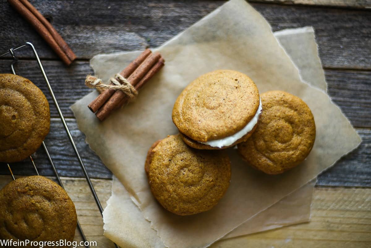 Three pumpkin whoopie pies with cream cheese filling 