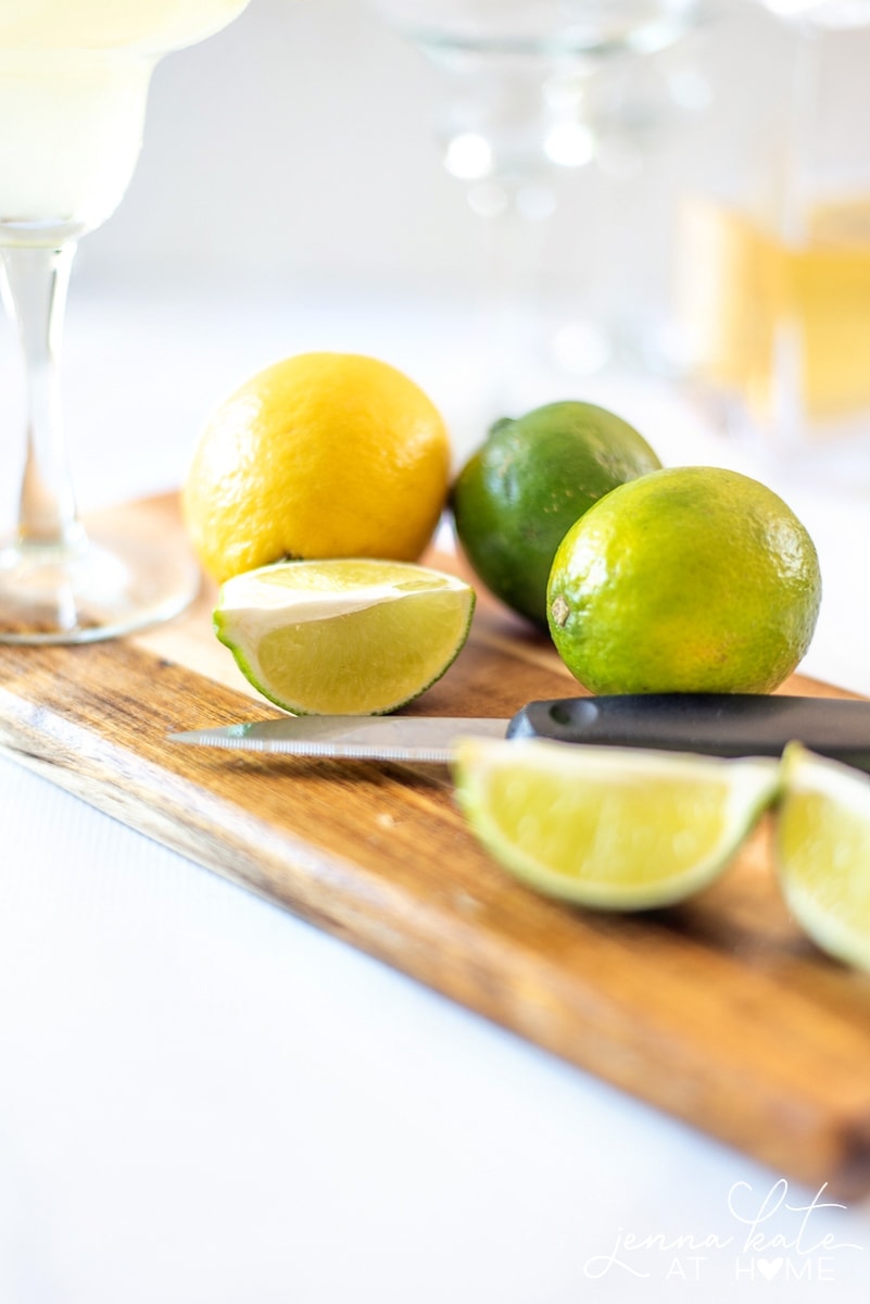 Cut lemons and limes for the homemade margarita mix