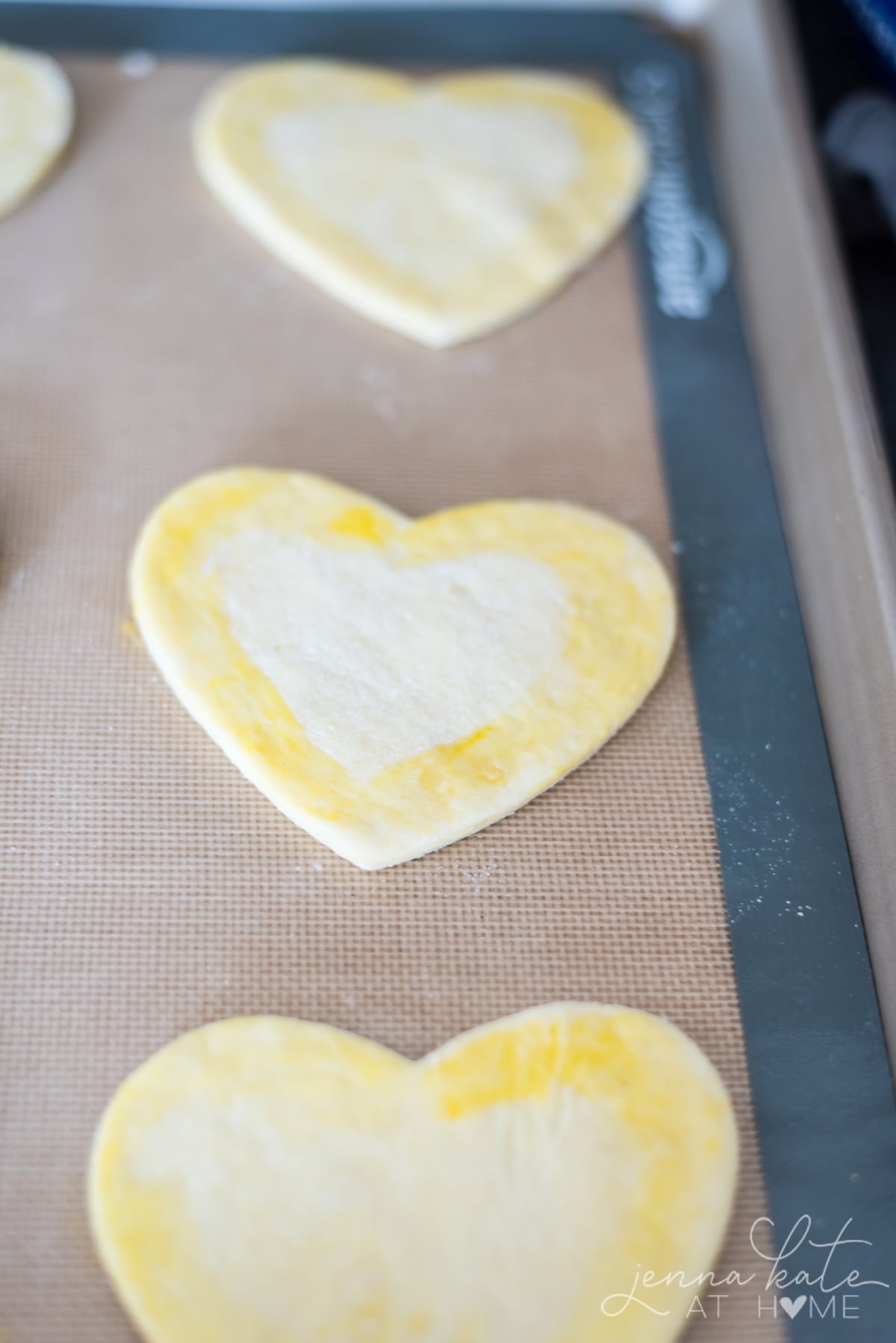 Heart shaped pastry cut out on a silicone baking mat