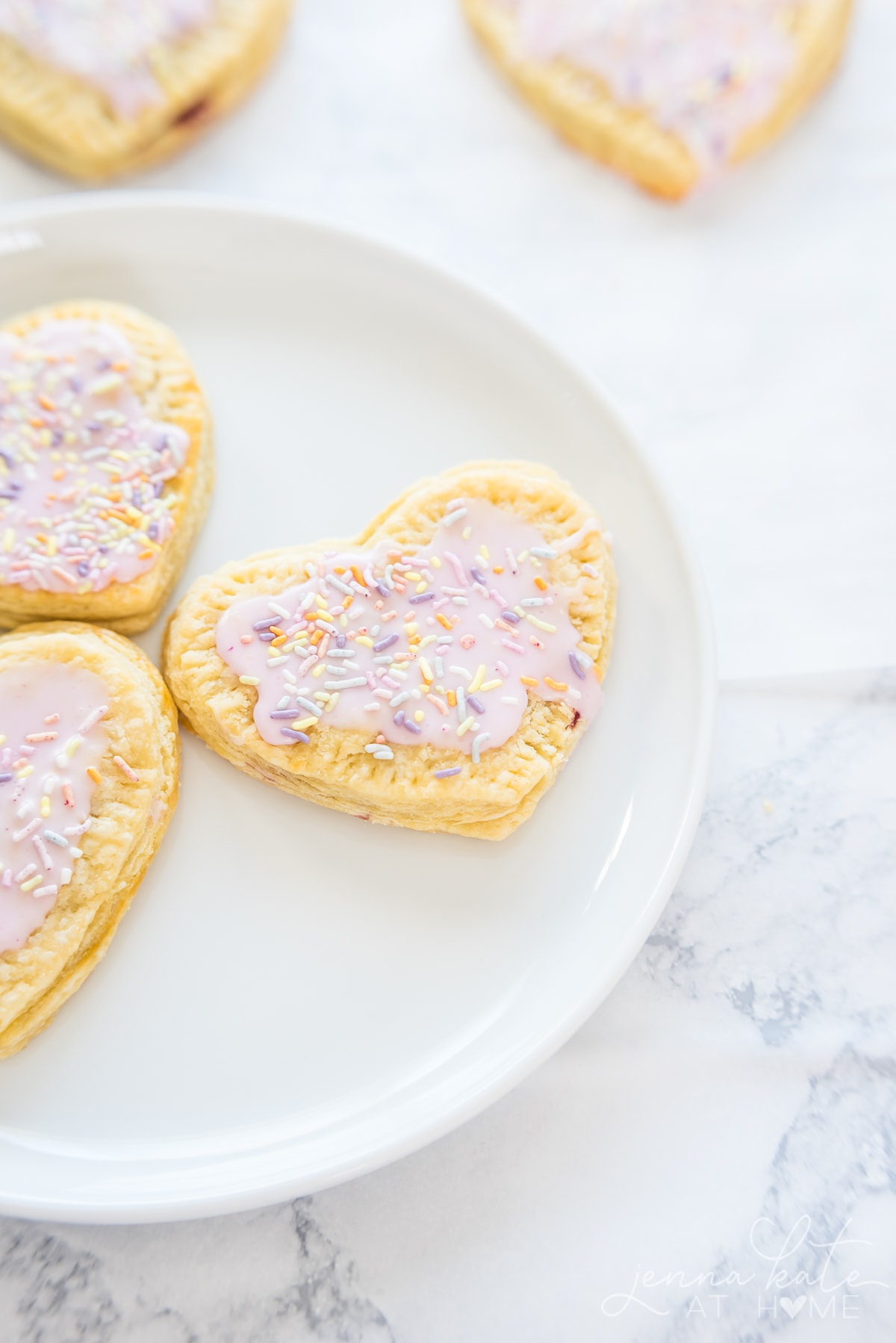 heart shaped homemade pop tarts with pink frosting and sprinkles