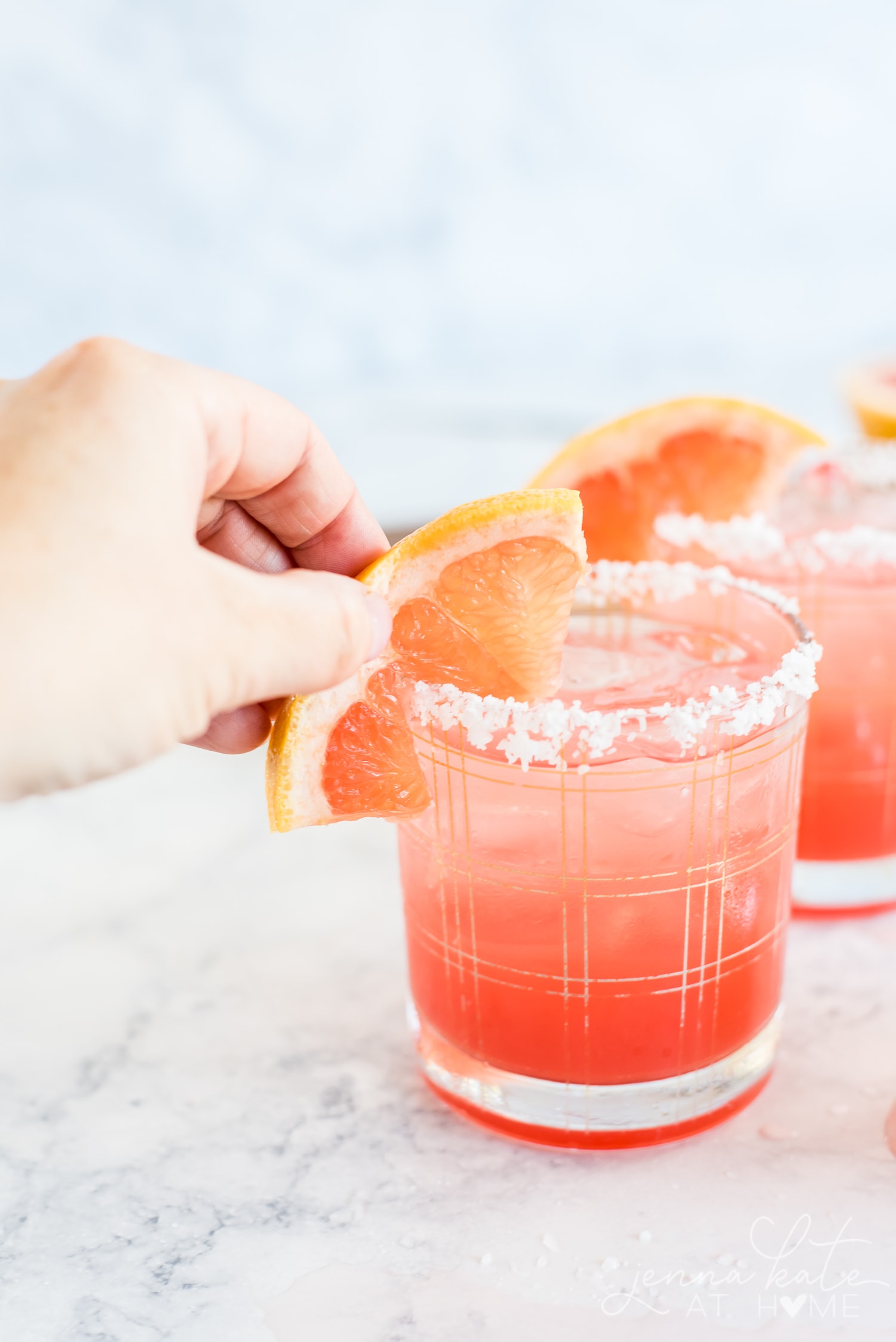 Garnishing the glass with a wedge of grapefruit
