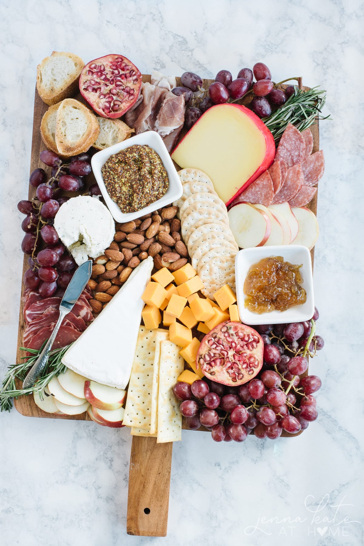 Charcuterie board for a wine tasting party filled with fruits, cheeses, meats and crackers