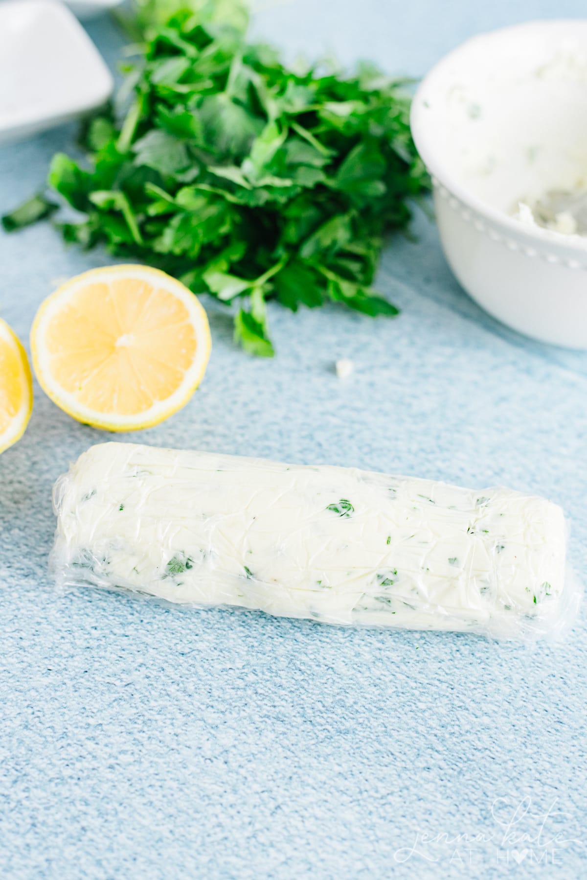 garlic herb butter log wrapped in plastic wrap