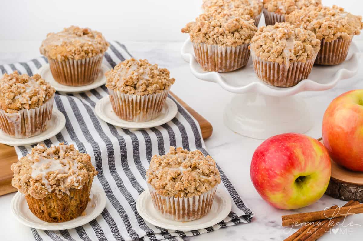 cinnamon apple muffins on a cake stand and cutting board