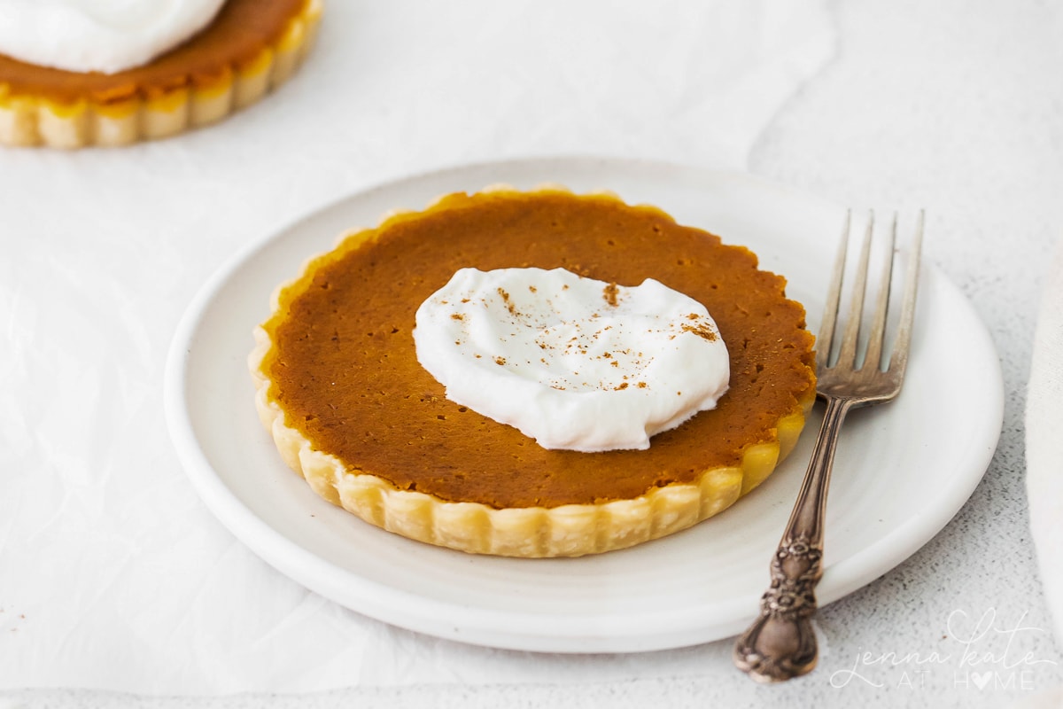 mini pumpkin pie on a plate with a fork