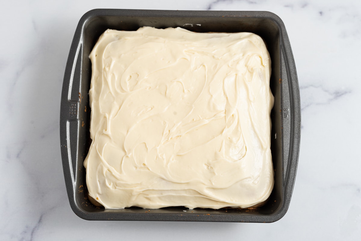 old fashioned spice cake in the pan with cream cheese frosting 