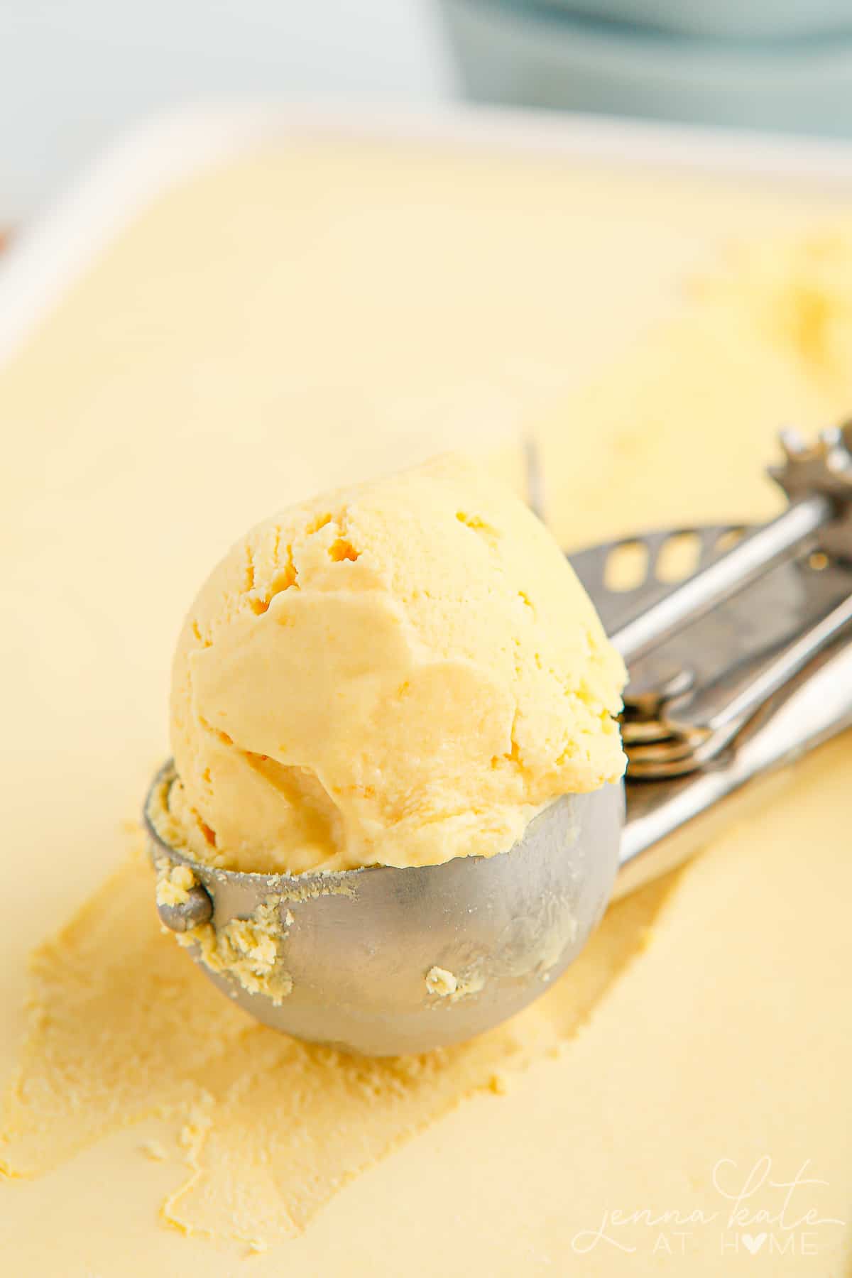 close up of scoop of creamy mango ice cream