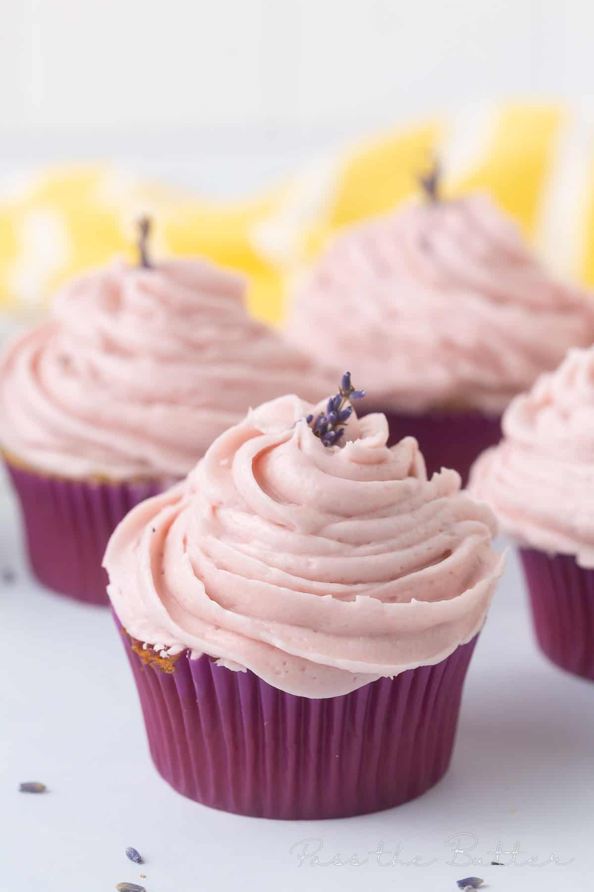 lavender cupcakes with violet frosting on a countertop. 