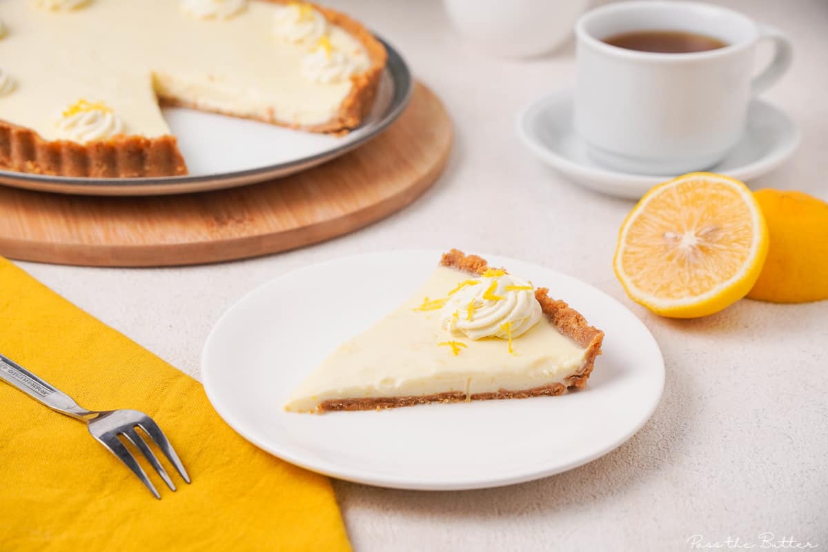 Slice of easy no bake lemon tart on a white plate.