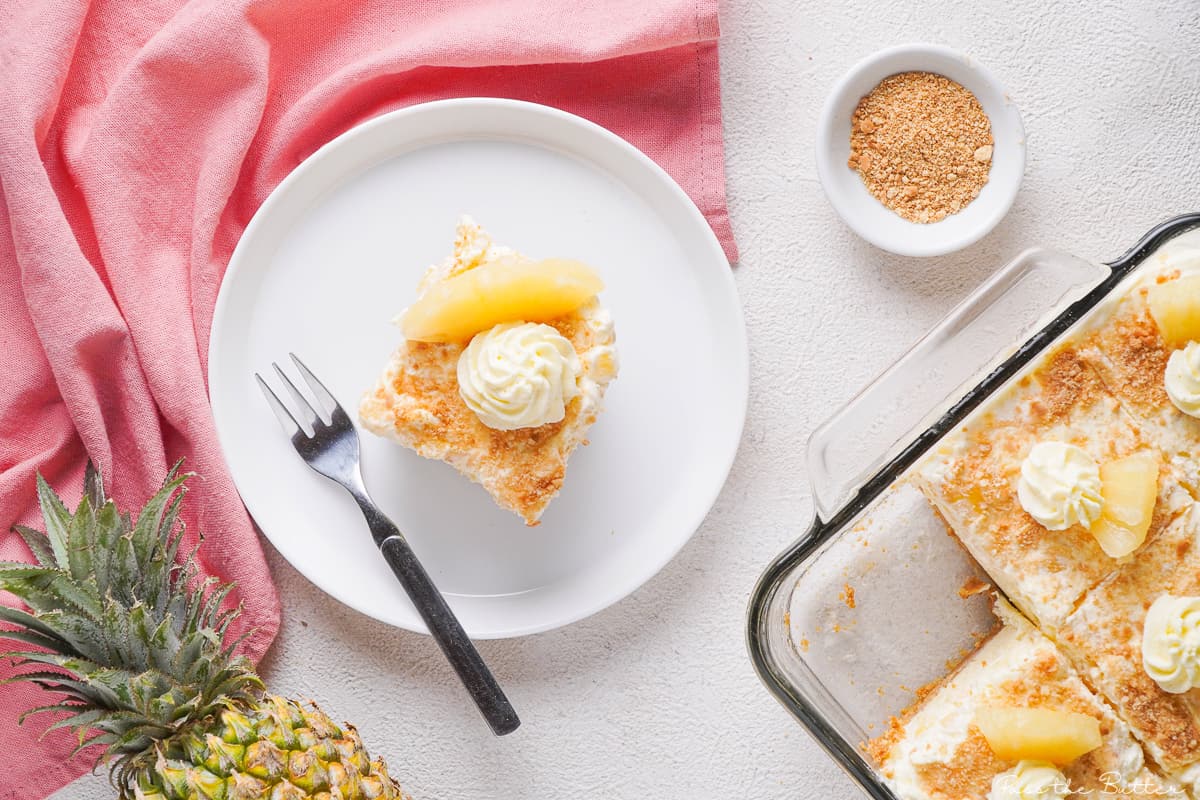 Slice of pineapple cream pie on white plate with a fork.