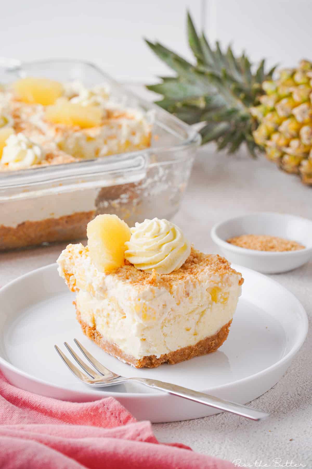 Slice of pineapple cream pie on a white plate.