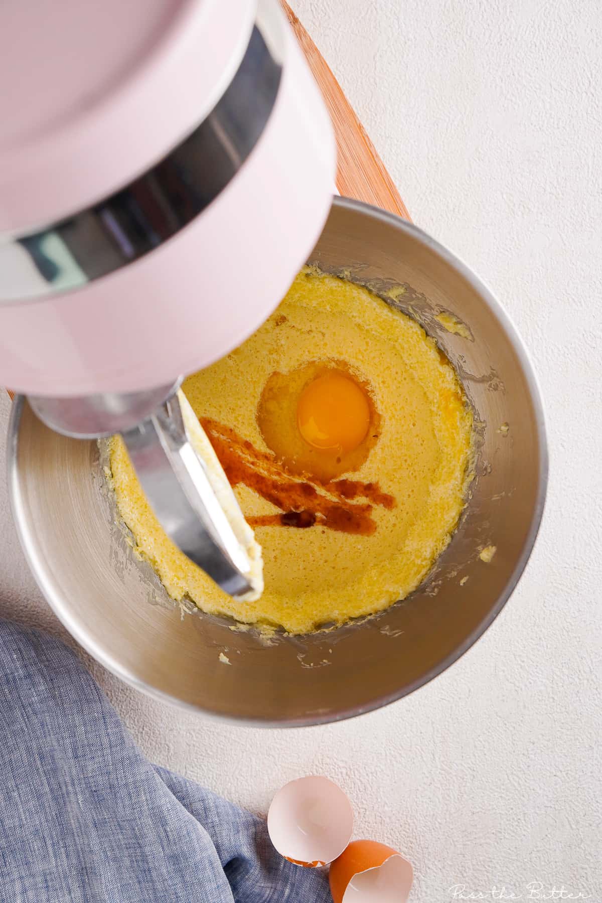 adding the eggs into the stand mixer bowl
